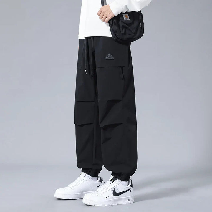 Modern men's activewear joggers with secure zipper pockets & tapered fit. Great for utility, comfort, & casual wear.