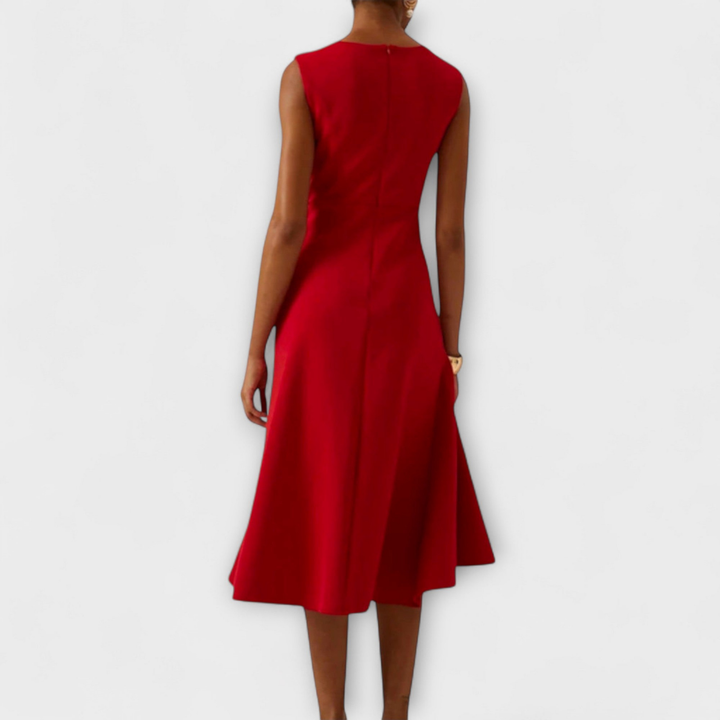 Sophisticated draped knot women's midi dress. Sleeveless design with a flattering silhouette and stylish ruffle hem.
