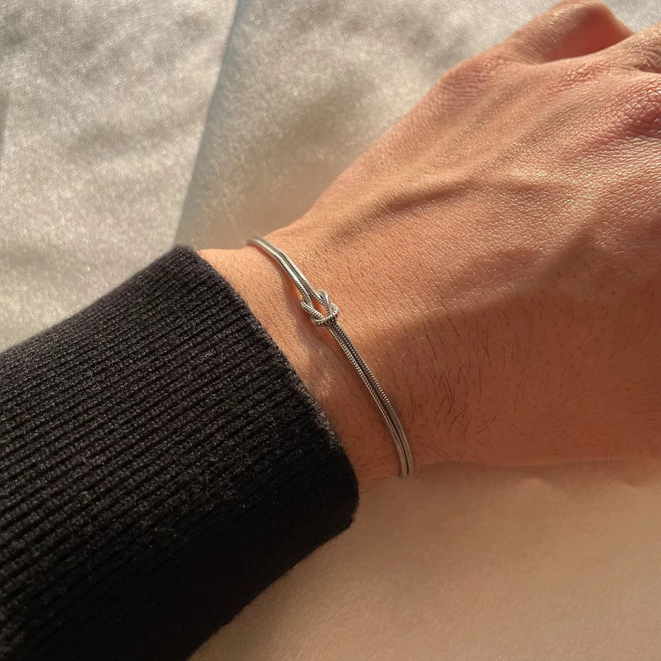Stylish gold-tone stainless steel Endless Knot bracelet for men & women. Tarnish-free & water-resistant.