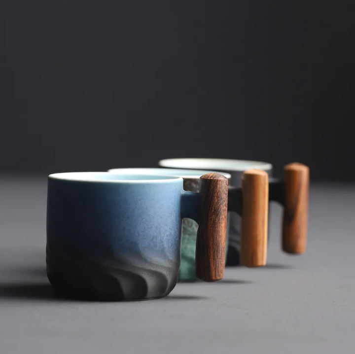 Small retro ceramic espresso mug, a perfect piece of drinkware with a wooden handle.