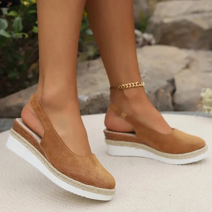 Woman wearing posture-enhancing orthopedic sandals, offering arch support & comfort for summer walking.