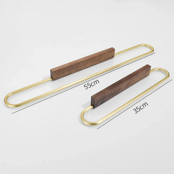 Stylish walnut towel bar, wall mounted. A modern wood accent with brass details for upscale bathroom decor.