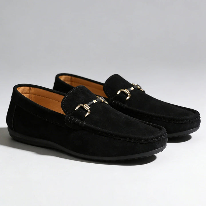 Comfortable men's dress shoes: classic slip-on loafers with a distinctive polished metal buckle.