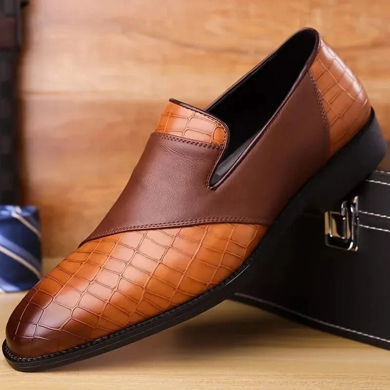 Tan leather men's slip-on loafers, showcasing premium material & classic stitching detail.