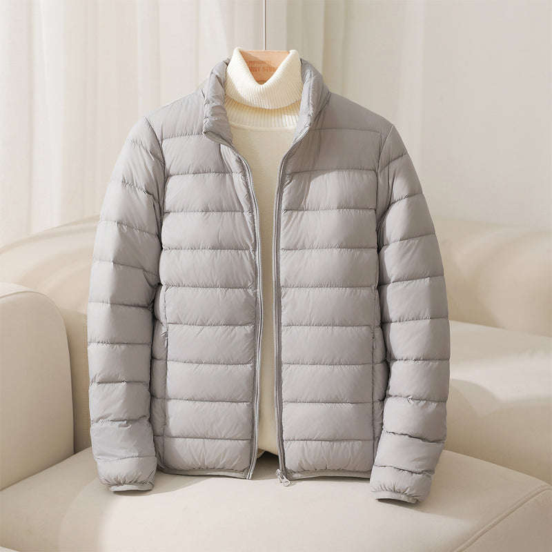 Blue women's lightweight quilted puffer jacket for winter. Stylish, warm, and comfortable outerwear.