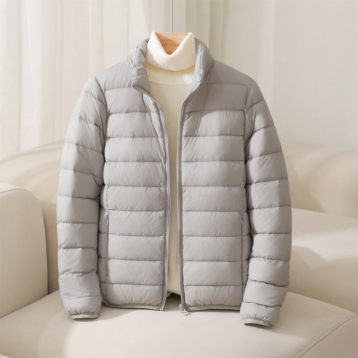 Blue women's lightweight quilted puffer jacket for winter. Stylish, warm, and comfortable outerwear.