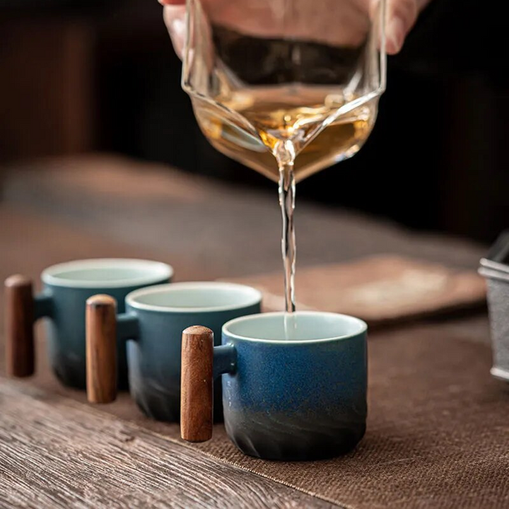 Retro ceramic espresso mug with wooden handle, filled with rich coffee.