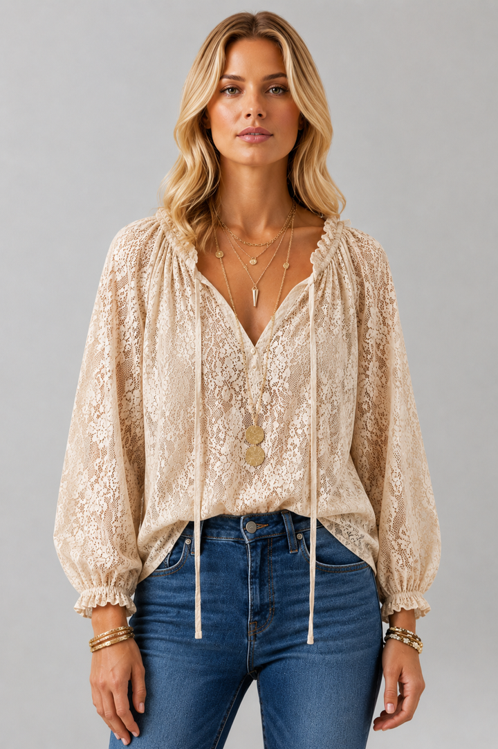 Full shot of a women's elegant lace blouse, long sleeve with a sophisticated tied neckline. Versatile fashion.