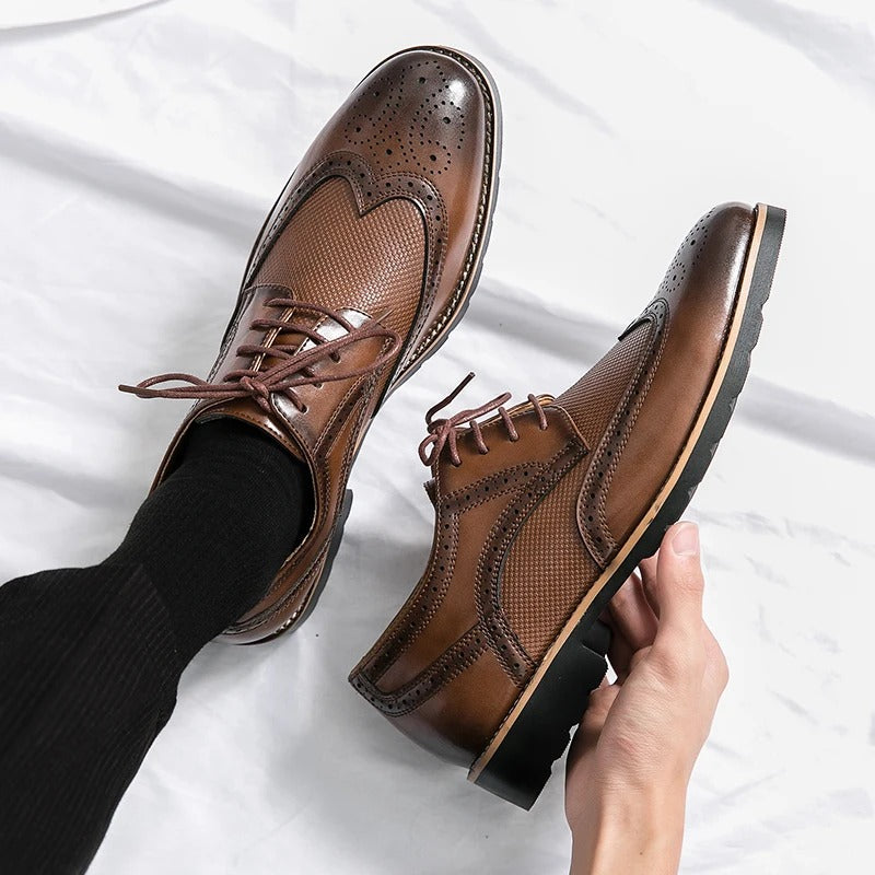 Elegant black leather brogue dress shoes for men, featuring classic perforations. Ideal for formal wear and business attire.