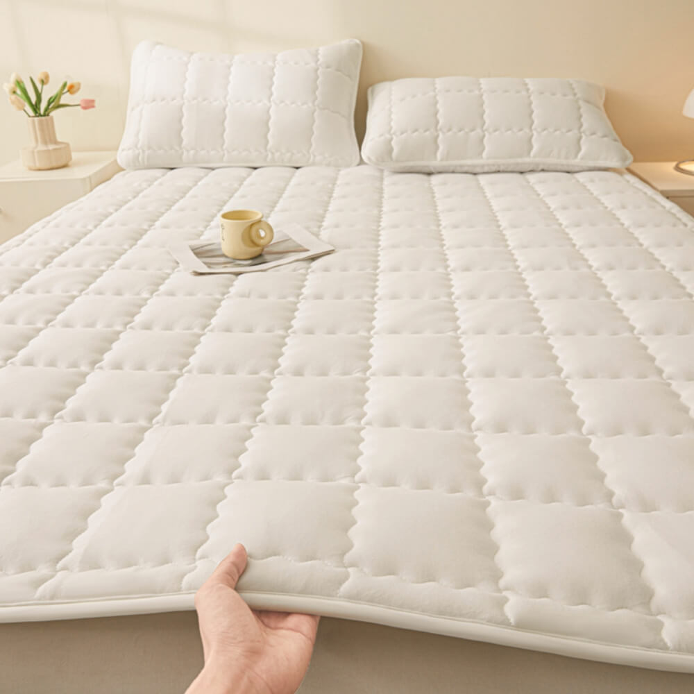 Hand touching the soft, quilted surface of the breathable all-season mattress topper, comfort assured