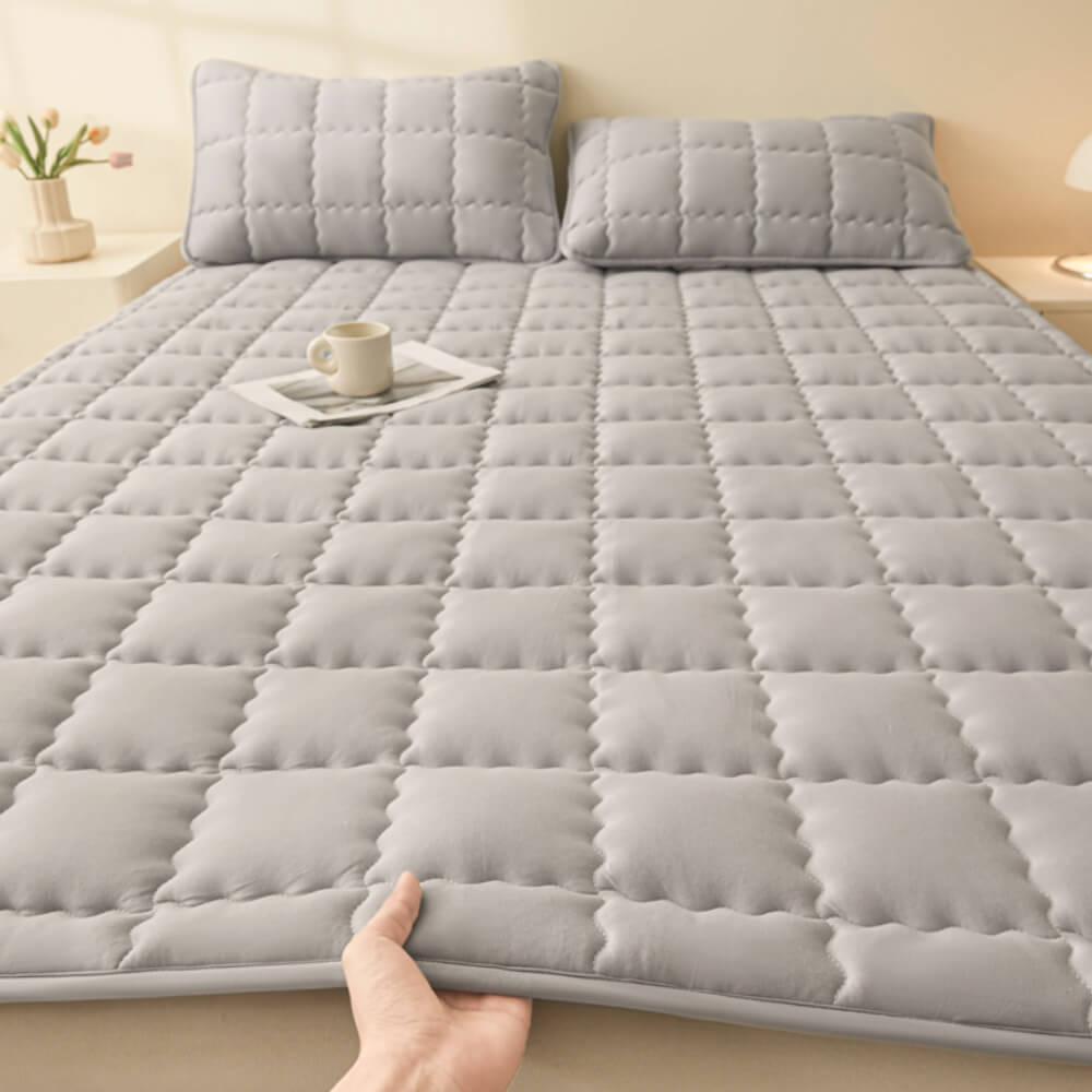 Bedroom featuring a bed with the breathable non-slip mattress topper and other home textiles