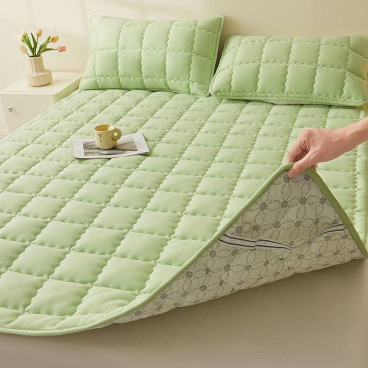 Corner view of the non-slip mattress topper with elastic skirt, fitted securely to a bed mattress