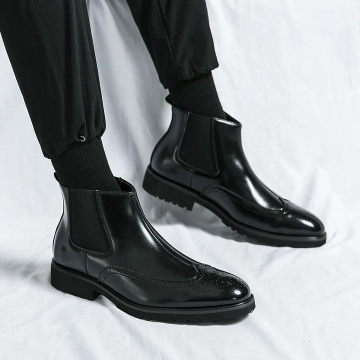 Men's smart chelsea boots, brogue accents elevate this durable design for any setting.