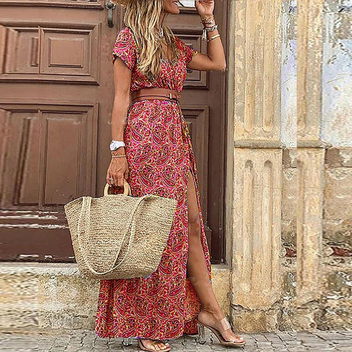 Flowy women's bohemian maxi dress, vibrant floral print, V-neck, short sleeves, and side split.