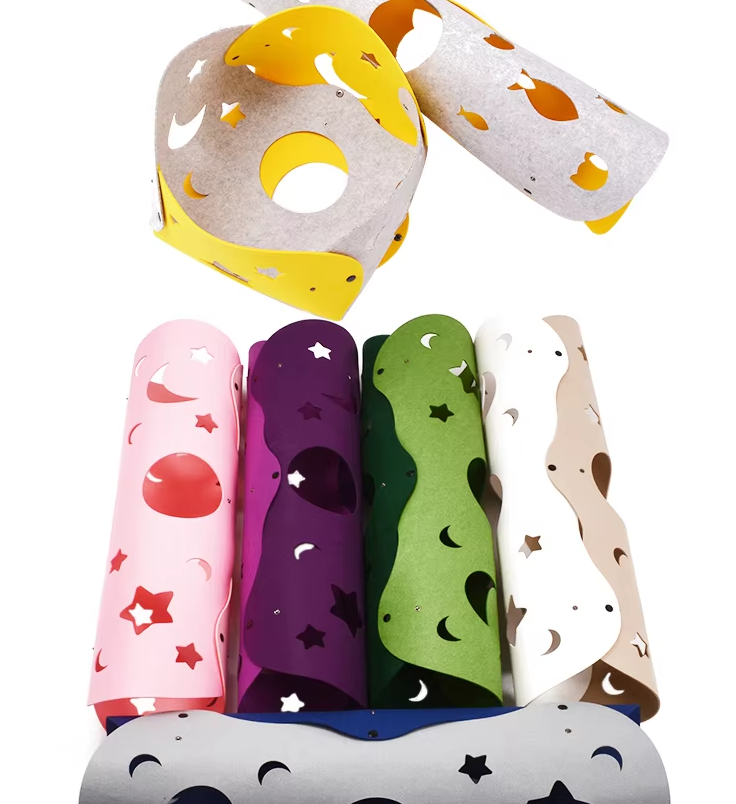 Close-up of a cat's paw reaching through a peek hole of a gray flexible interactive play tunnel toy.