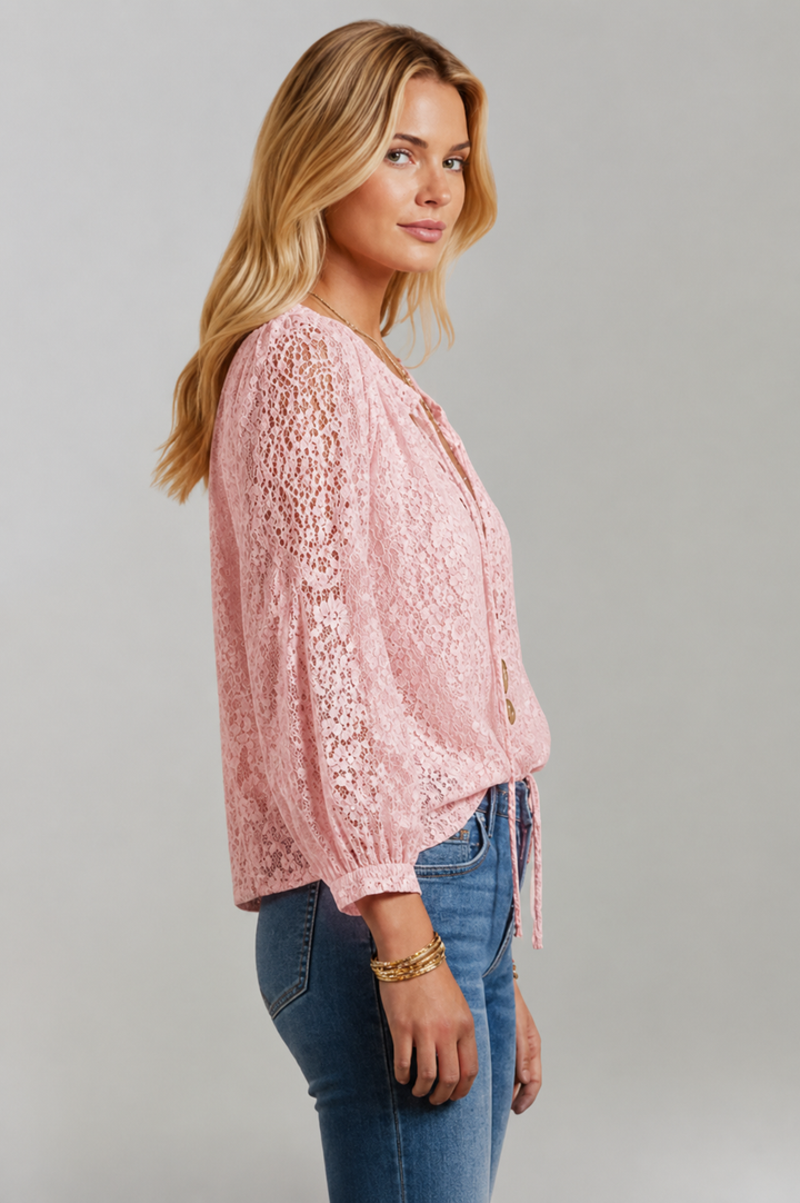 Stylish women's long sleeve lace blouse. Elegant design with a tied neckline, perfect for feminine fashion.
