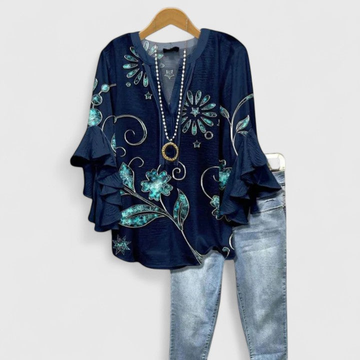Trendy women's floral blouse, perfect for any occasion. This chic top features a vibrant print & elegant design.