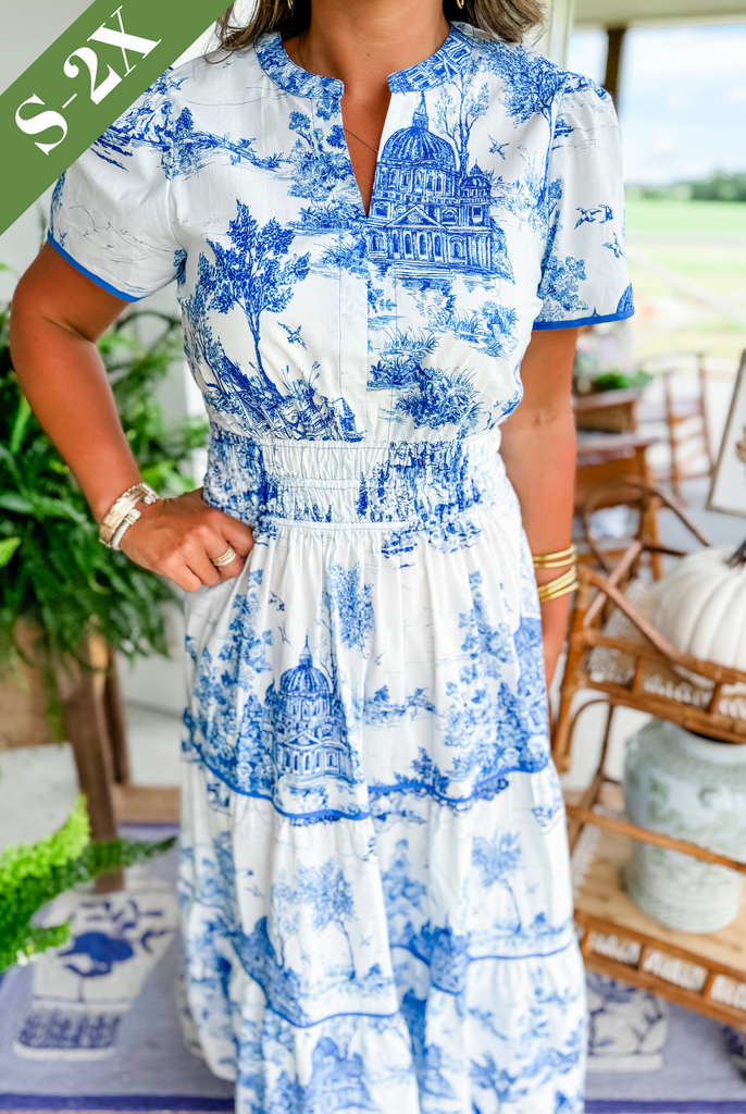 Women's tiered maxi dress, fashionable toile print, smocked waist, and puff sleeve detail. Chic occasion wear.