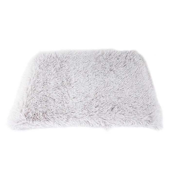 Calming pet blanket draped over a sofa, protecting upholstery while offering comfort for a dog or cat