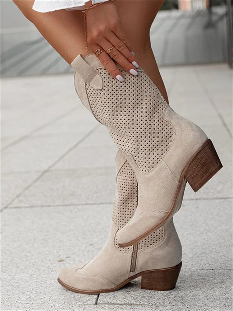 Stylish women's western ankle boots with side zip, comfortable block heel, & unique perforated design.