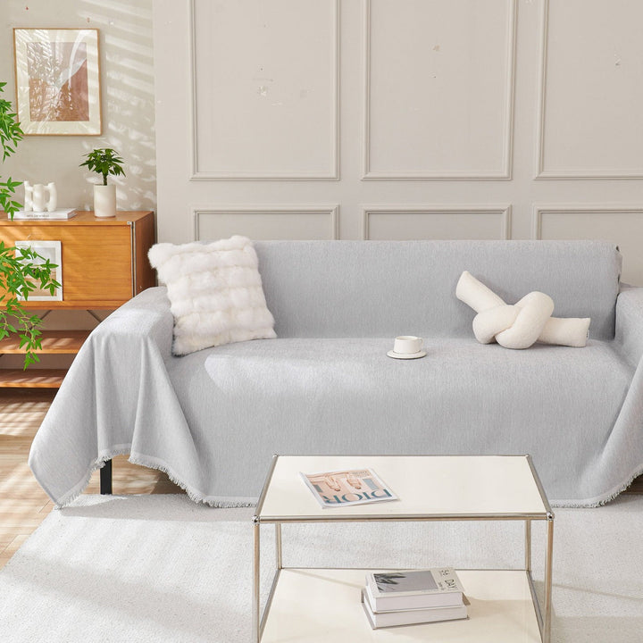 Stylish & durable sofa couch cover in modern grey, protecting furniture. A chic living room slipcover.