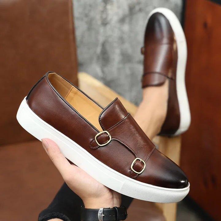 Detailed view of the double buckle monk strap on premium men's dress loafers, classic formal footwear.
