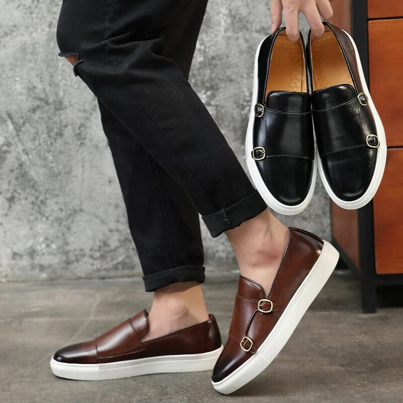 Front view of sophisticated men's black monk strap shoes, offering timeless style & comfort.
