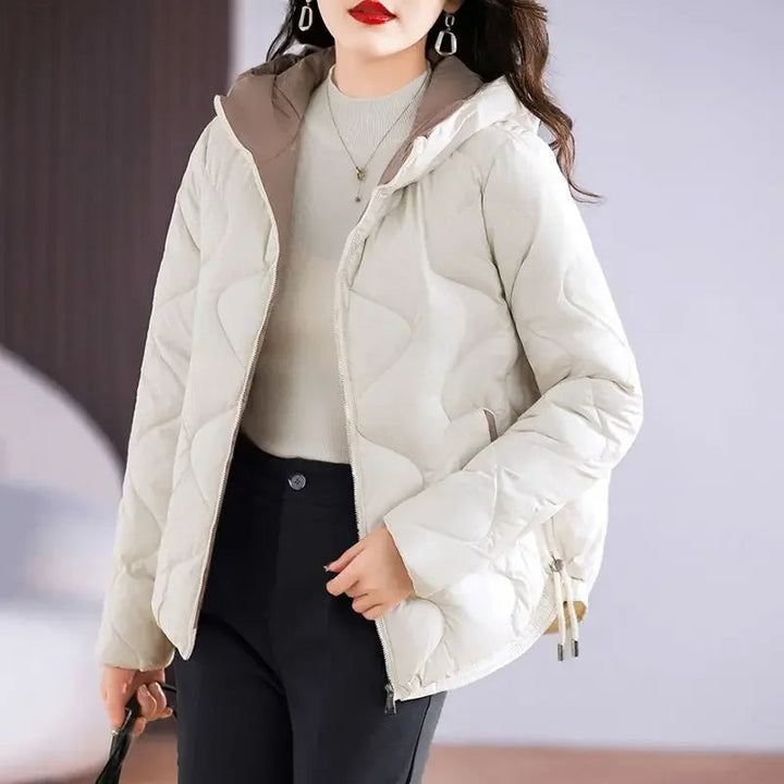 Woman wearing a stylish quilted puffer jacket, ideal for cozy fall and winter warmth.