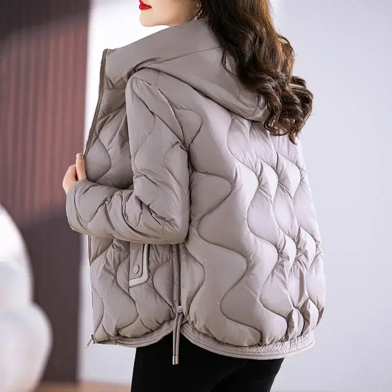 Chic women's quilted puffer jacket, a versatile outerwear choice for casual elegance & warmth.