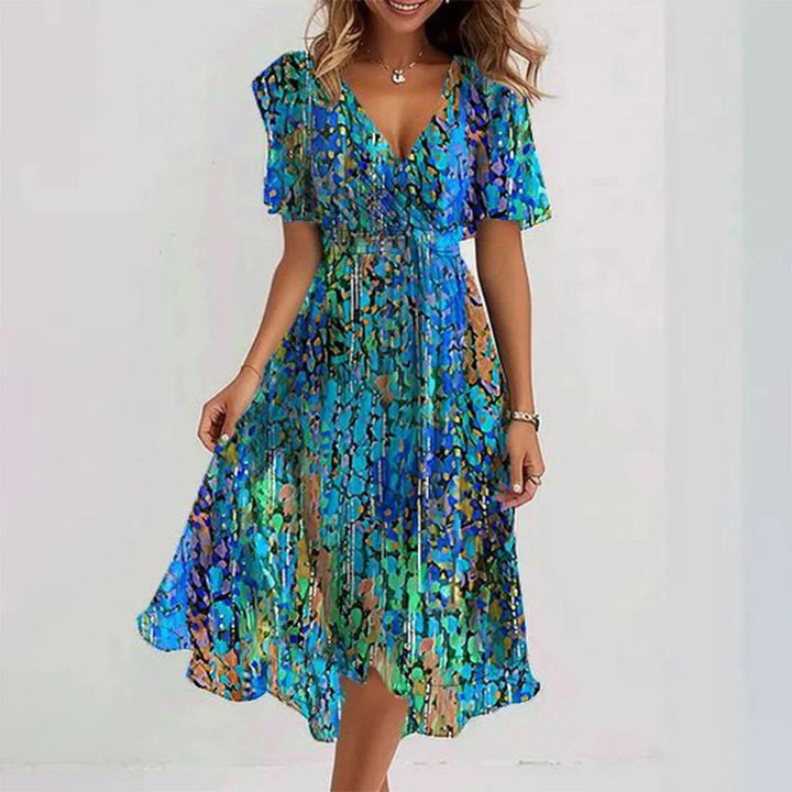 Flowy floral print wrap midi dress for women. Elegant flutter sleeves, ideal for summer parties or events.