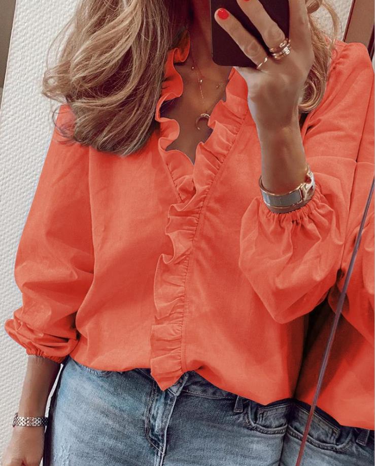 Stylish women's top: elegant ruffled V-neck blouse in a comfortable fit, ideal for office or sophisticated casual.