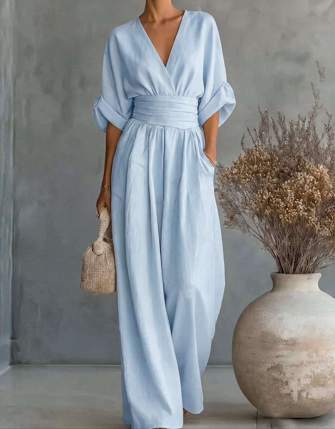Versatile women's wide-leg jumpsuit with wrap front. Elegant one-piece for chic occasion wear.