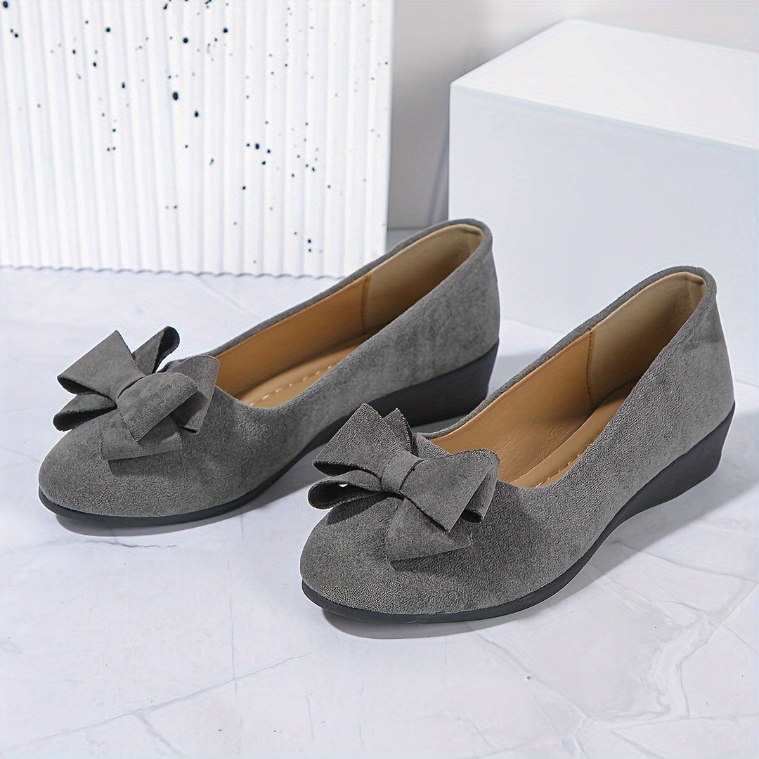 Comfortable women's dressy flats with arch support and bow.