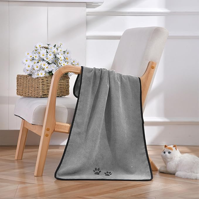 Pet owner drying a happy dog with a gray microfiber pet towel, showcasing the hand pockets.