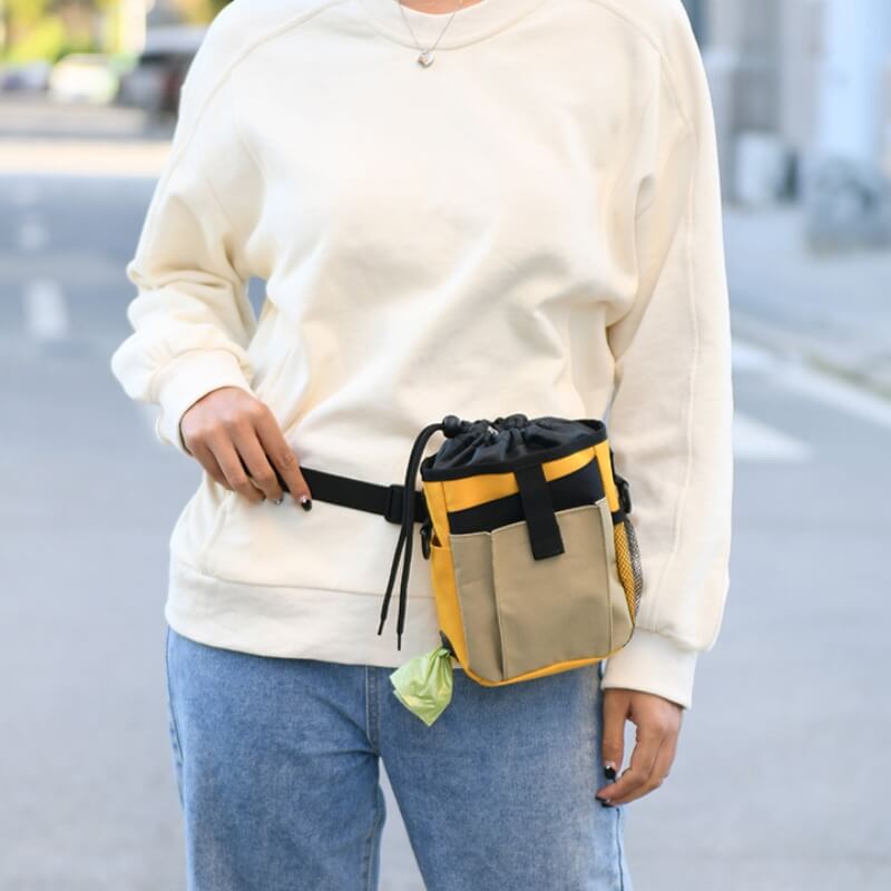 Durable hands-free treat bag for pet training, featuring a secure drawstring top and D-ring for keys