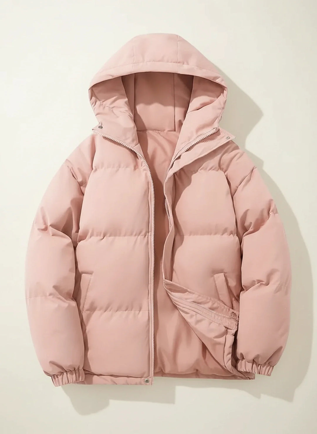 Elegant women's quilted puffer jacket with a soft hood, ideal for chilly winter fashion.