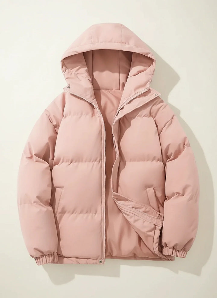 Elegant women's quilted puffer jacket with a soft hood, ideal for chilly winter fashion.