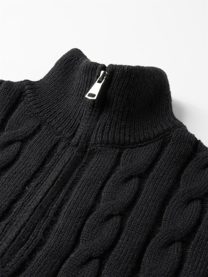 Man casually styled in a timeless cable knit quarter-zip sweater, embodying classic men's fashion and comfort.