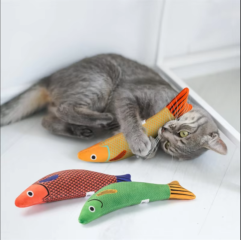 Cat playing with electronic fish catnip toy, promoting active playtime