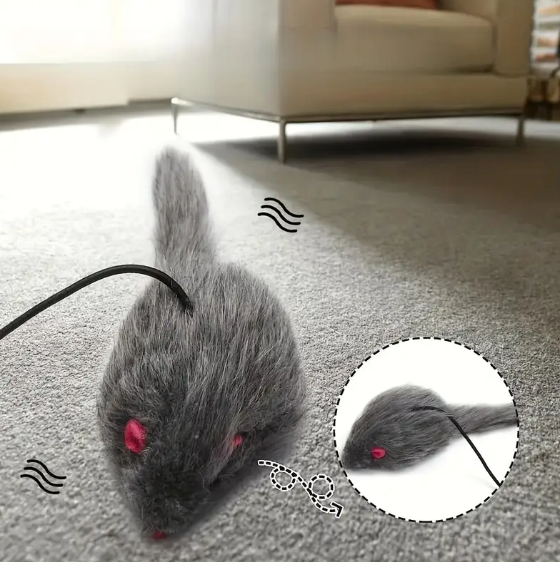Cat pouncing on an interactive mouse toy with a retractable string, promoting active play.