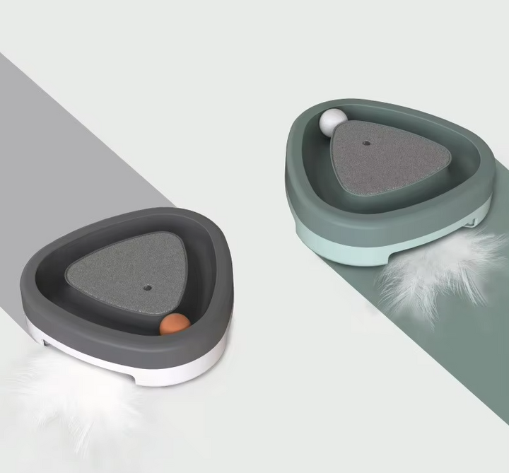 Cat batting at a ball in the play track of an interactive toy, promoting mental stimulation and physical activity