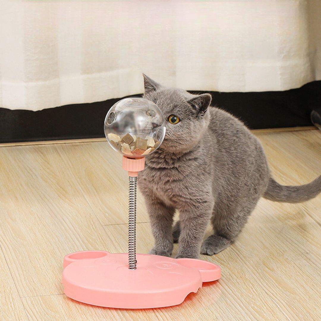 Interactive cat treat dispenser toy promoting mental stimulation and playtime for felines.