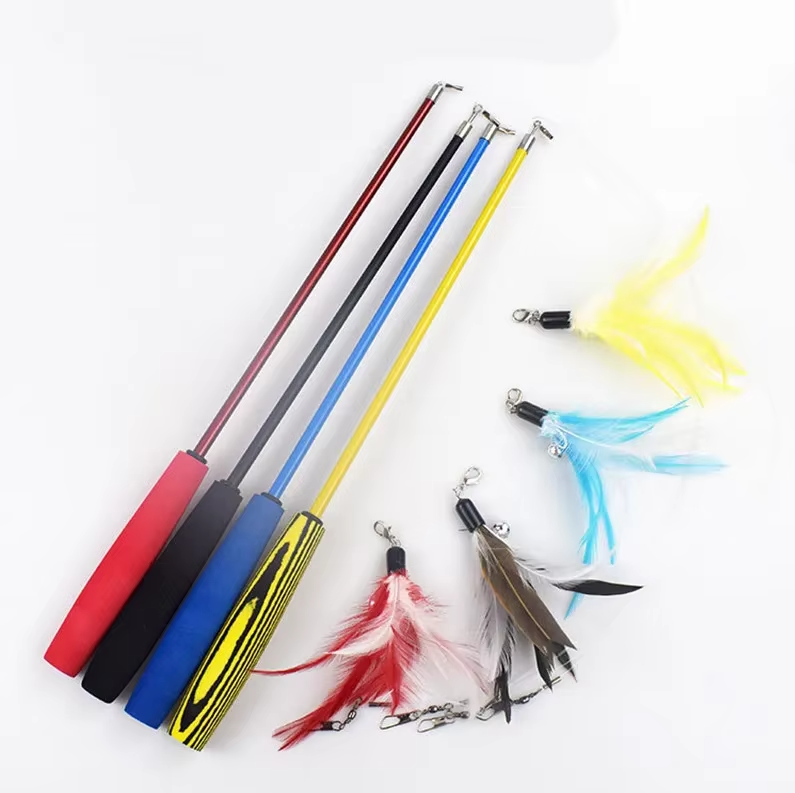 Cat pouncing on an interactive feather wand toy, promoting healthy exercise and engagement