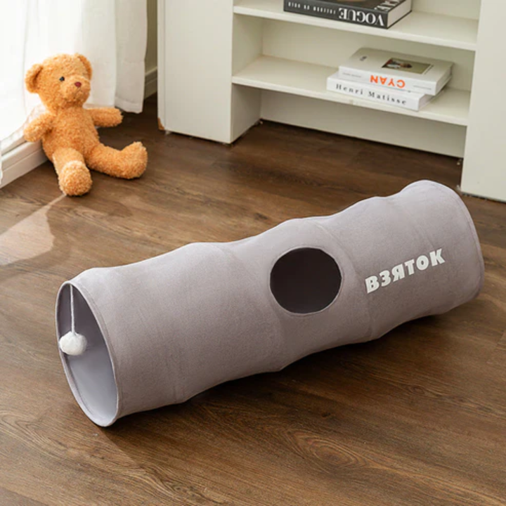 Interactive foldable cat play tunnel with peep hole for indoor cat enrichment and fun.