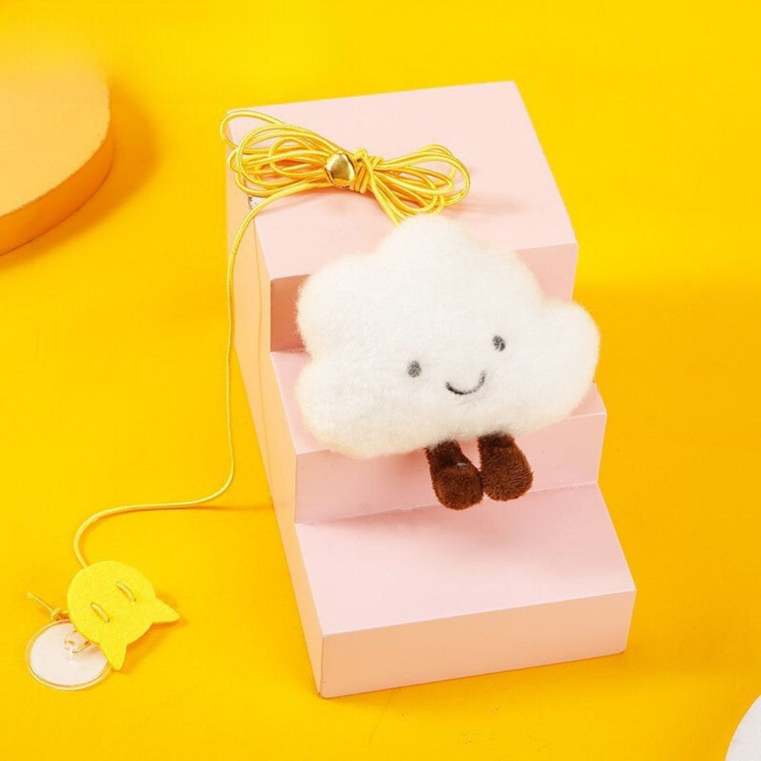 Playful cat engaging with a suspended bell toy, a stimulating feline activity.