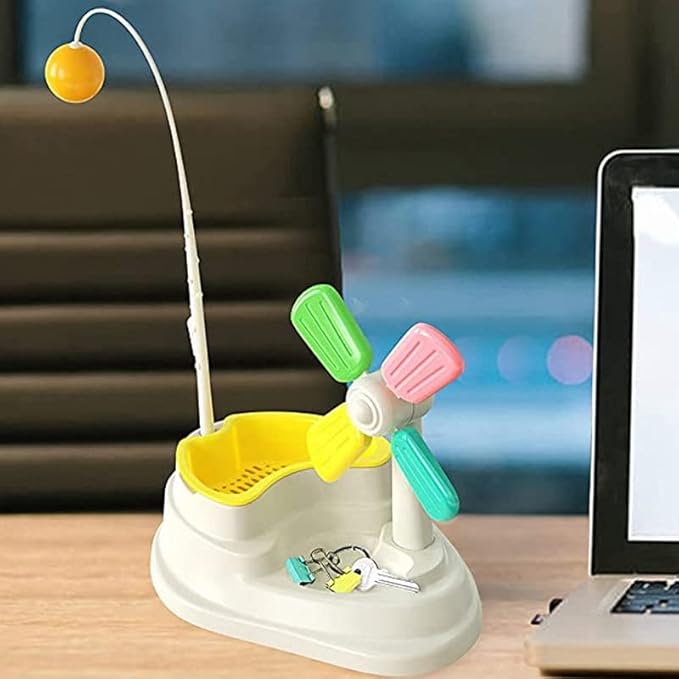 Cat batting an interactive windmill toy, promoting mental stimulation and physical activity