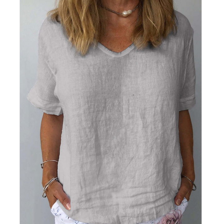 White relaxed fit V-neck short sleeve blouse for women, ideal for versatile everyday comfort & spring style.