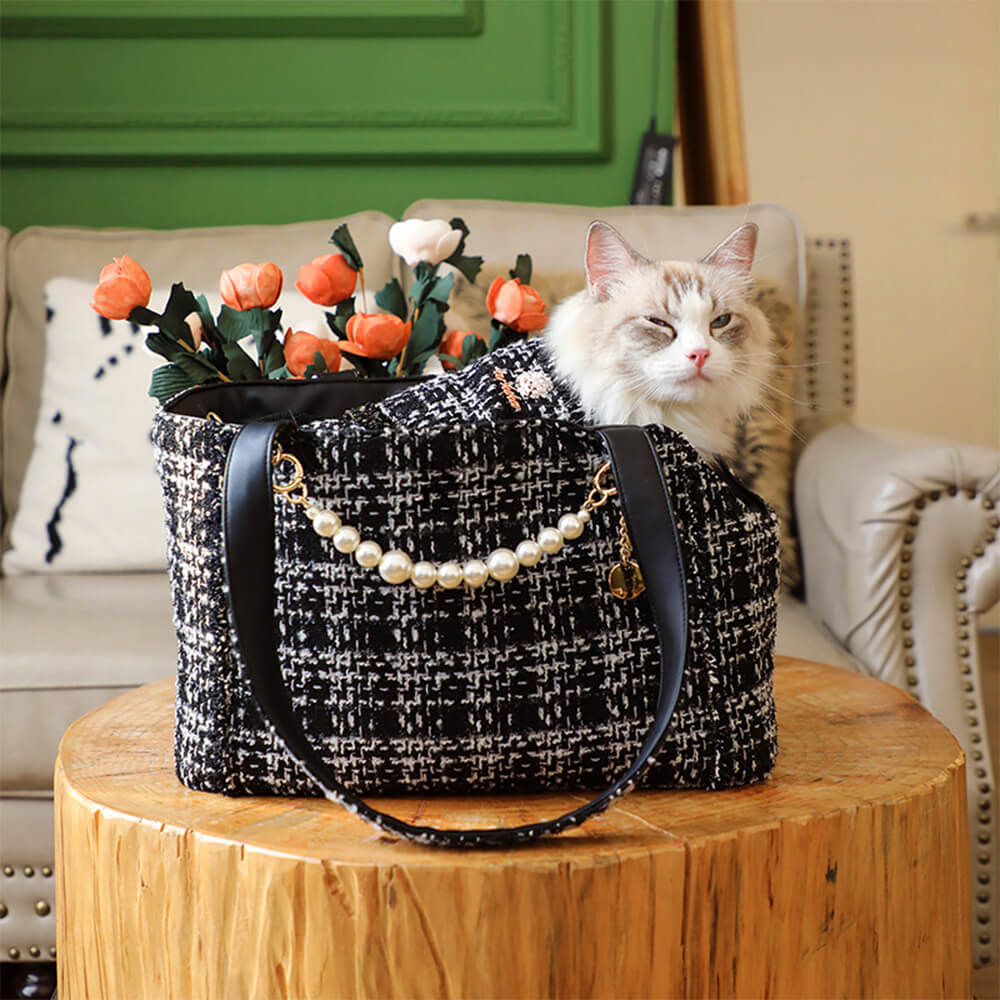 Luxury pet travel bag, tweed textile, for small dogs, featuring safety leash clip inside.