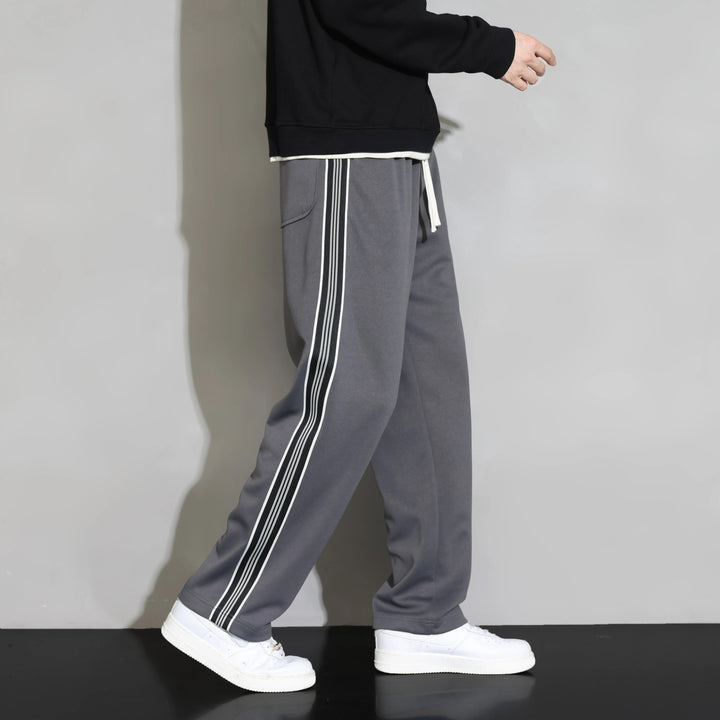 Comfortable men's polyester joggers with relaxed fit & distinctive stripe design for casual wear.