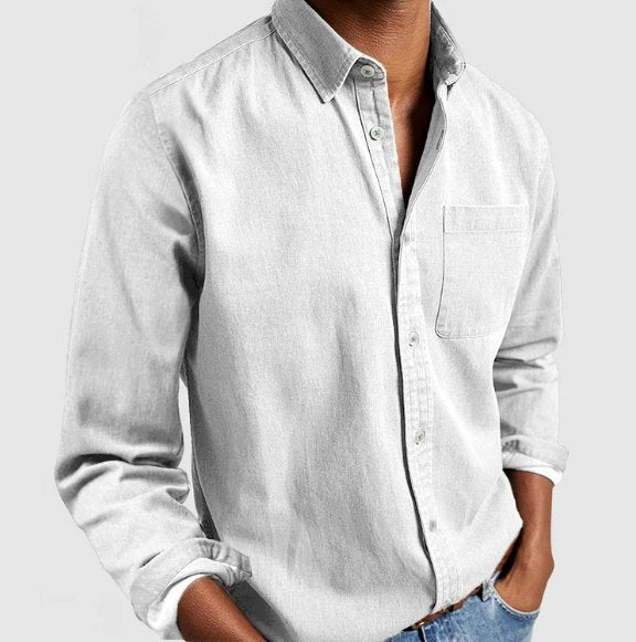 Man in a classic denim button-up shirt walking, embodying effortless style, casual fashion & everyday comfort.